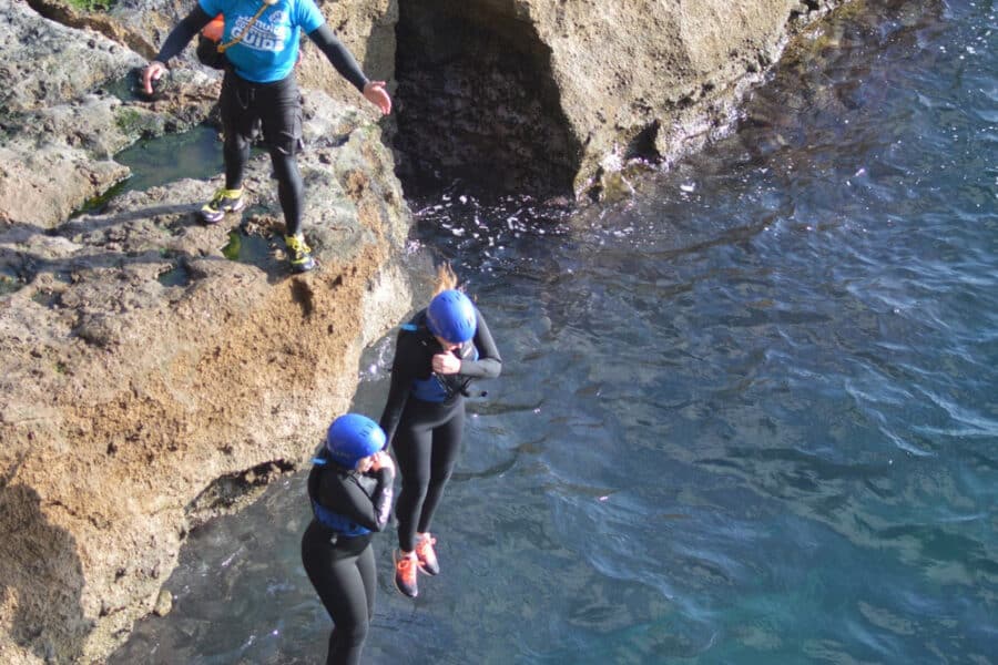 Two children jumping into the sea