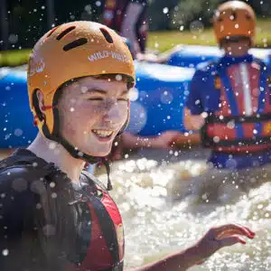 Teenager in lake raft building