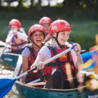 Girls paddling in a Canoe