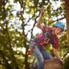 Boy on top of trapeze tower