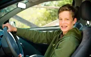 Teenage boy in the driver seat of a car
