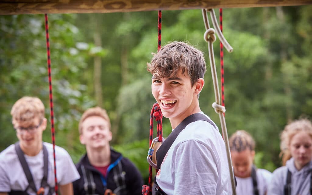 laughing teenagers in harnesses