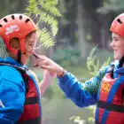 Children with leaves in their helmets
