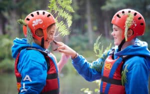 Children with leaves in their helmets