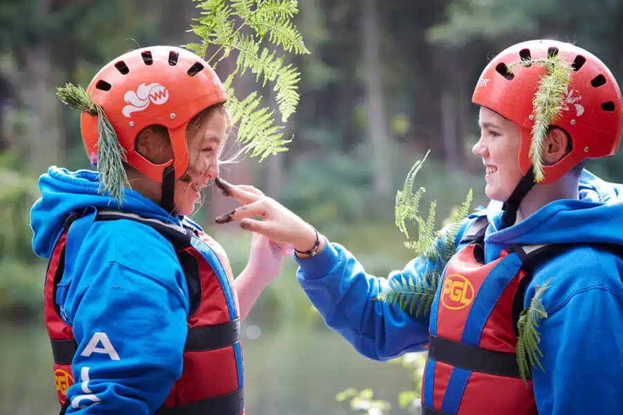 Children with leaves in their helmets