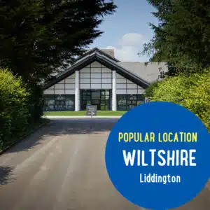 A road leading to a building with a sign pointing to a reception area. Text on the image reads, "Popular Location - Wiltshire - Liddington.