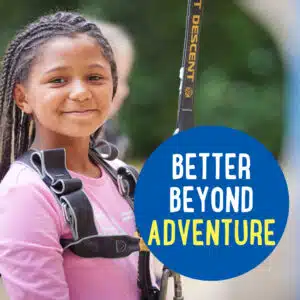 A young girl with braided hair, wearing a harness, smiles at the camera. The text on the image reads "BETTER BEYOND ADVENTURE.