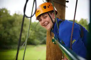 PGL Activity Instructor on the top of an abseil tower