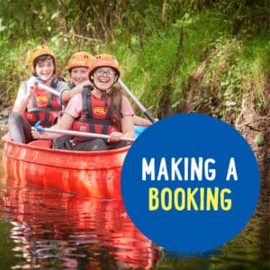 Three people in helmets and life vests paddle a red canoe, smiling, with a "Making a Booking" text overlay in a blue circle.
