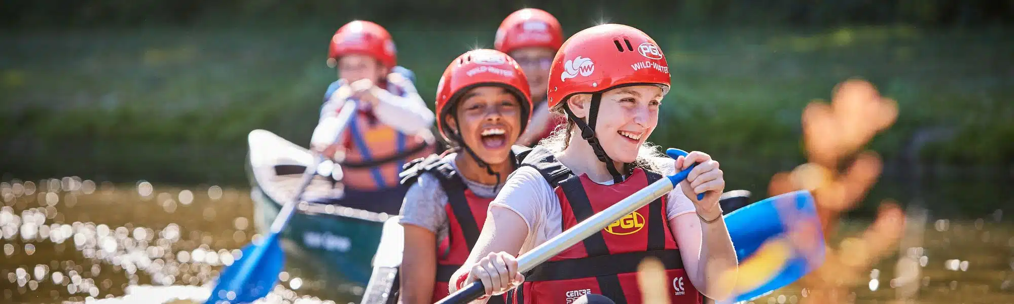 Two girls in a canoe, laughing