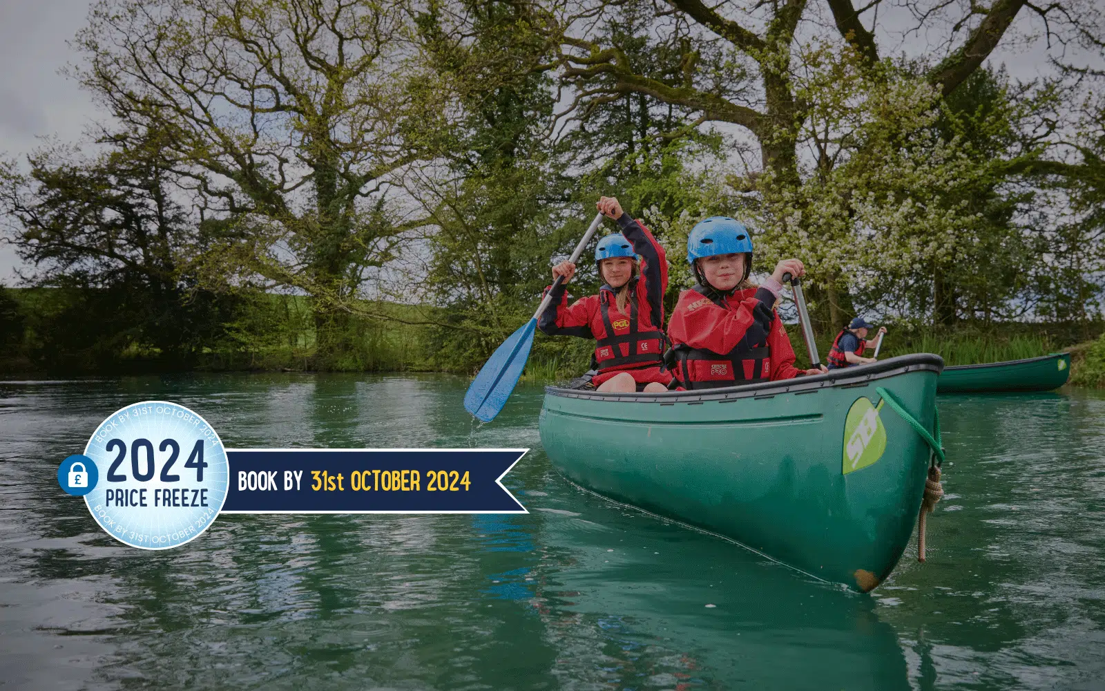 Two people paddle a green canoe on a calm lake surrounded by trees, embodying the spirit of PGL Adventure Holidays. A banner reads: "2024 Price Freeze. Book by 31st October 2024.