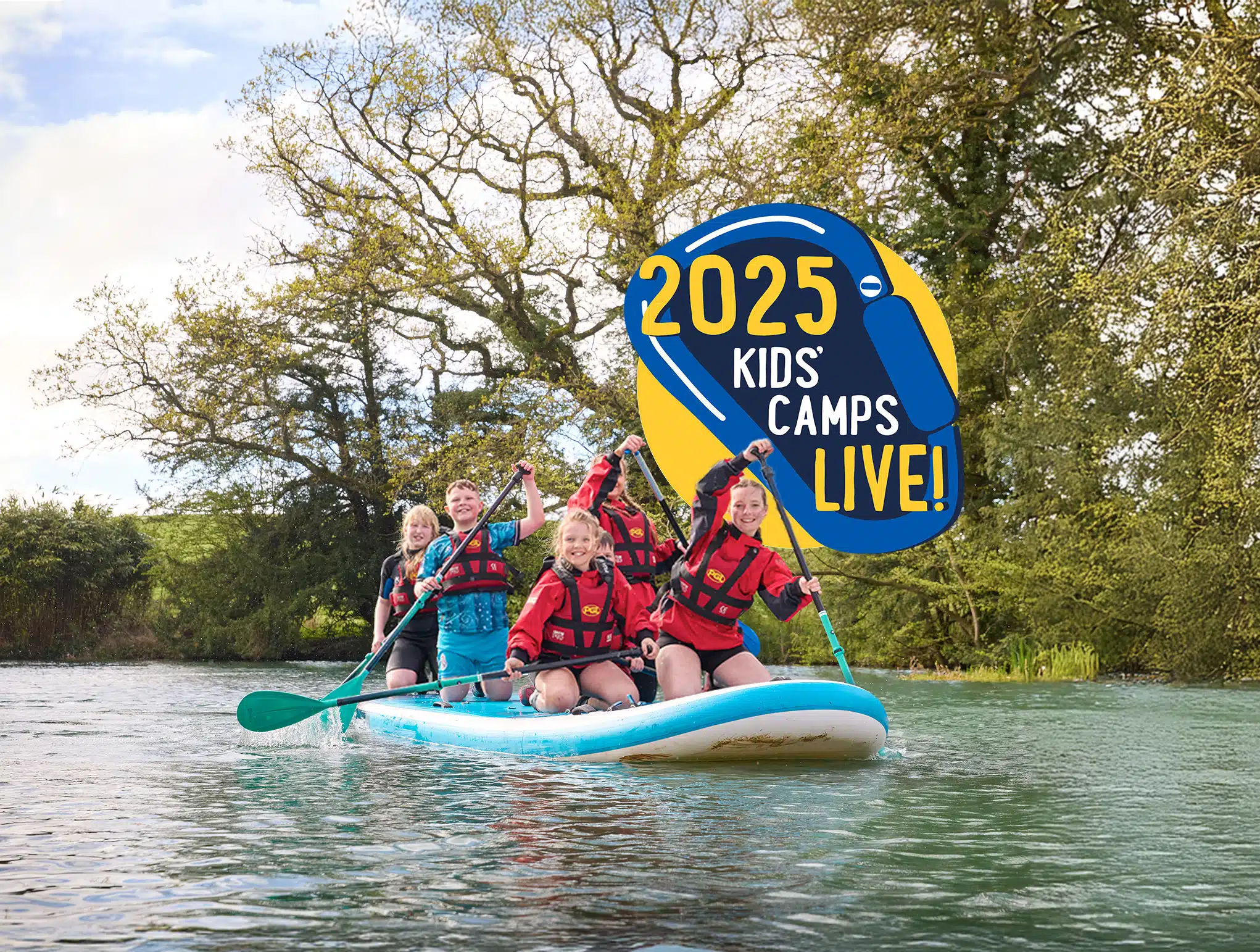 Four children in life jackets are paddling a large stand-up paddleboard on a lake. A logo reads "2025 Kids' Camps Live!.