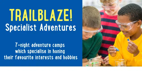 Children wearing safety goggles engage in a hands-on science activity at a Trailblaze Specialist Adventures camp.