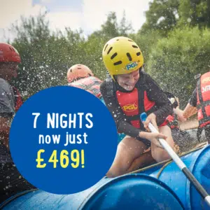 Child in a helmet rides a makeshift raft on water, smiling. Group behind assists. Blue circle reads: "7 NIGHTS now just £469!.