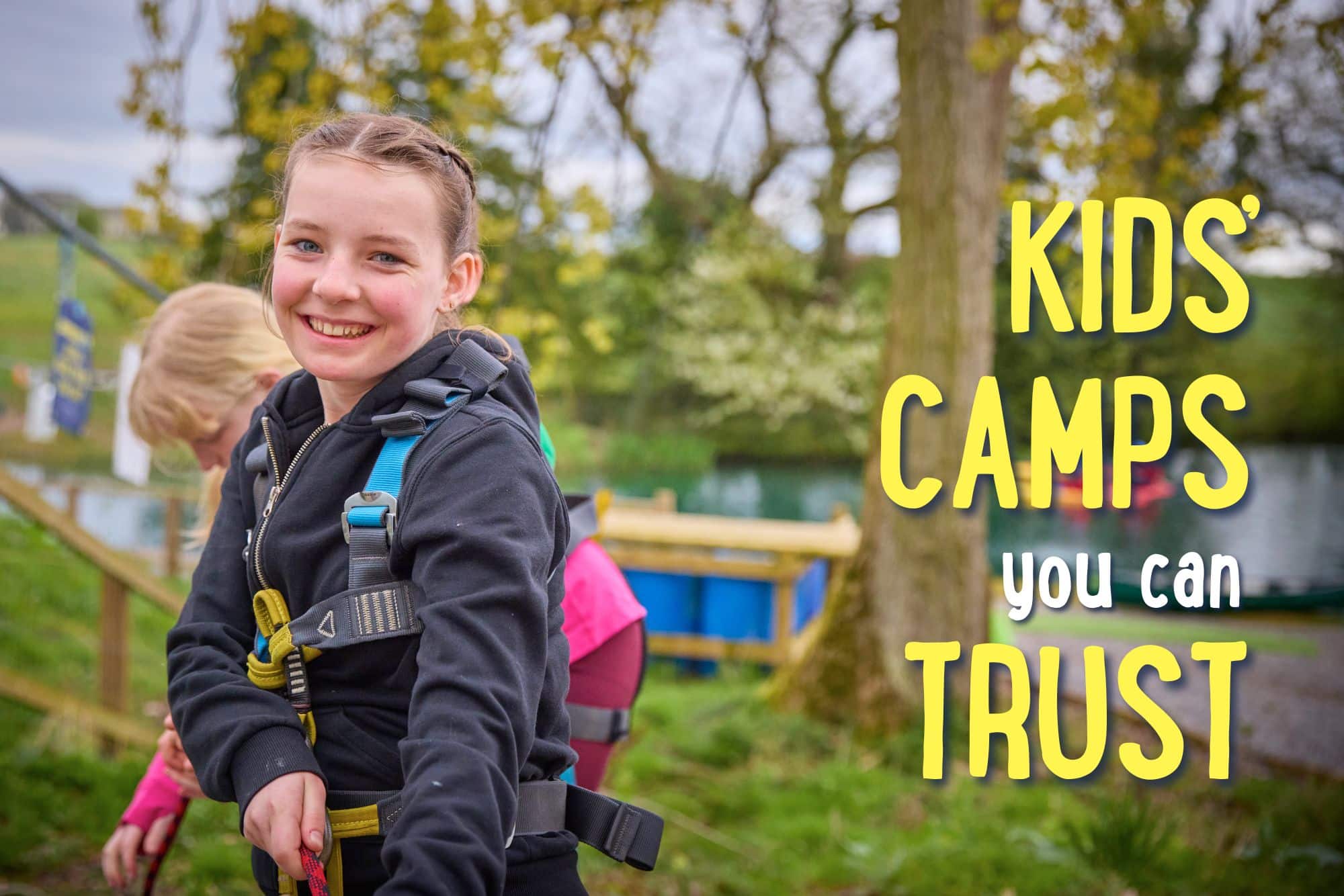 Smiling girl in outdoor gear stands in front of a harness course; text reads “Kids’ camps you can trust.”.