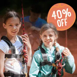 Two girls wearing harnesses and holding climbing ropes, standing outdoors, with a "40% OFF" badge in the top right corner.