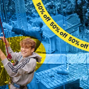 Two boys climbing ropes outdoors, one smiling at the camera. Image partially overlaid with blue and yellow colours and a “50% off” banner across the top.