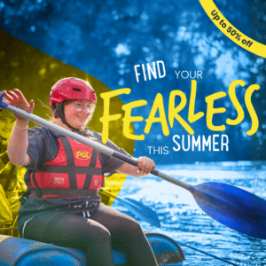 A young woman wearing a helmet and life jacket paddles a raft on water; text reads "Find your fearless this summer" and "Up to 50% off.
